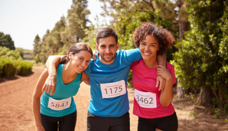 Three-happy-runners-hugging